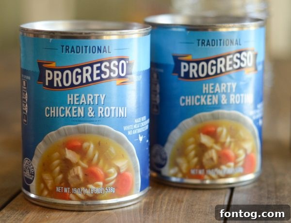 Two mason jars filled with soup and topped with golden cornbread