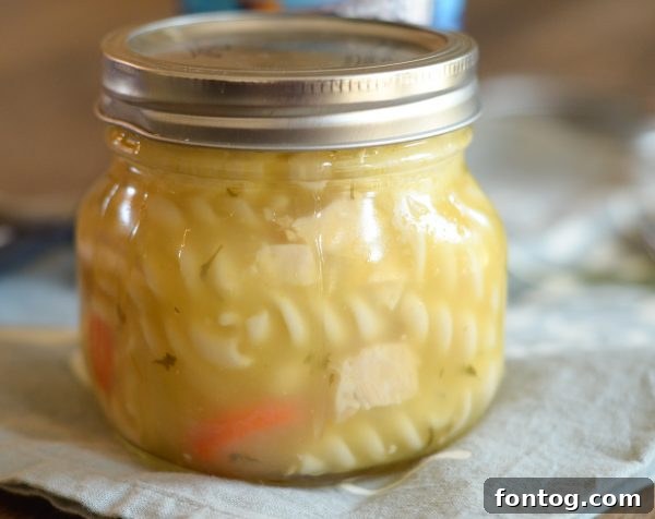 Baked cornbread topping on soup in a jar, ready to be sealed for portability
