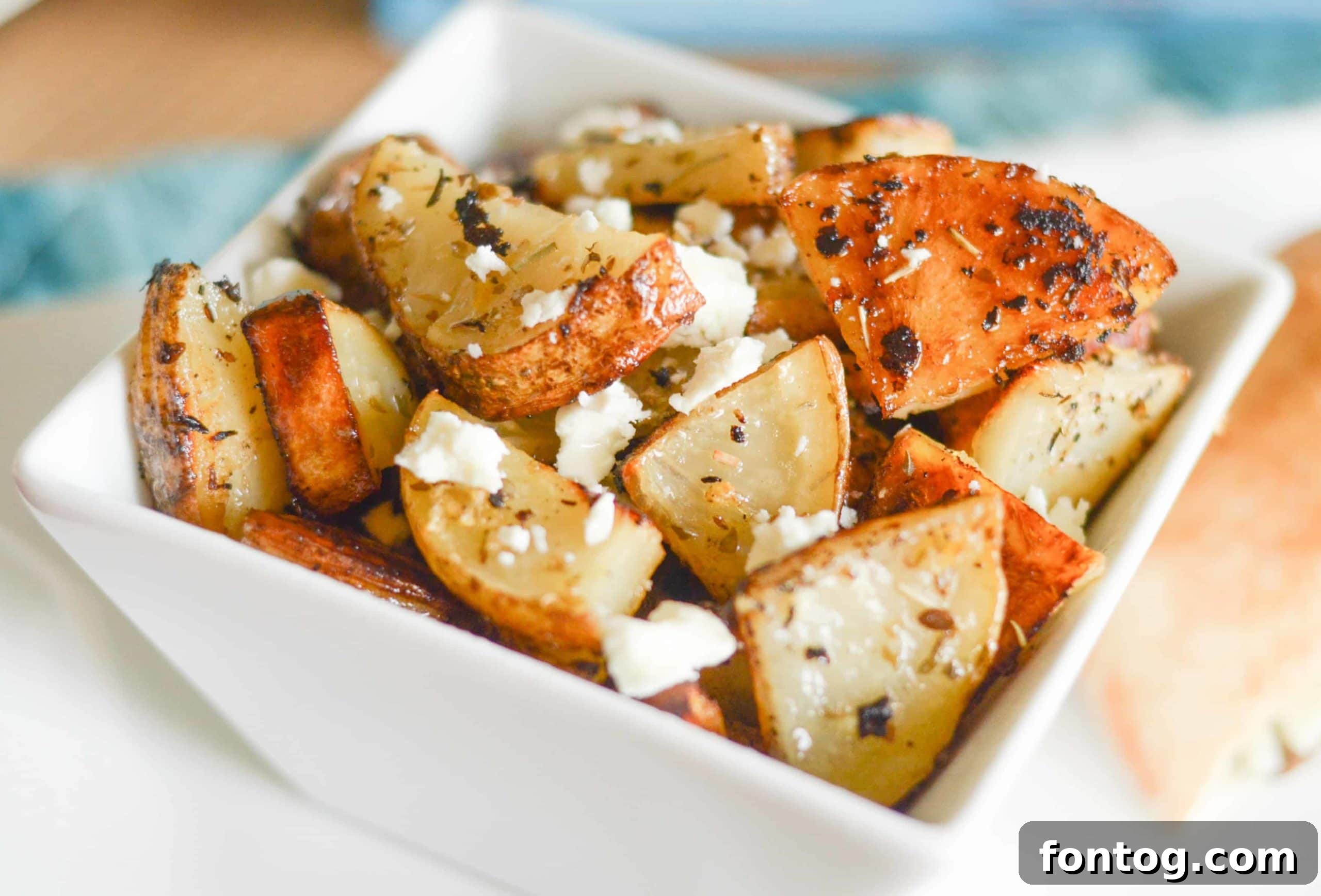 Plate of Roasted Greek Potatoes with a sprinkle of feta