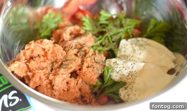 Mixing tuna salad ingredients