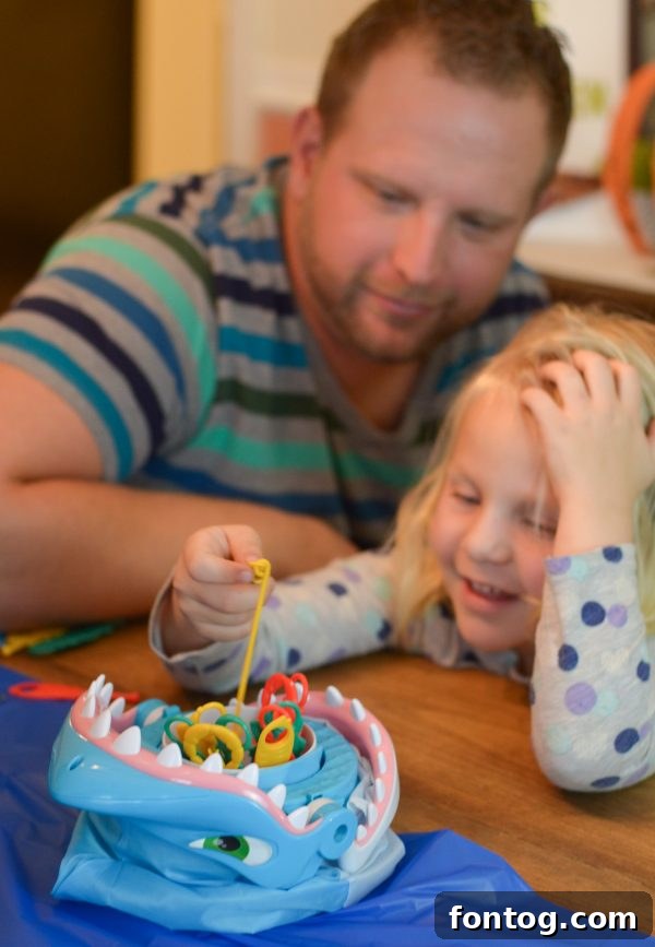 Close-up of children's hands reaching for game pieces, illustrating the engaging nature of game night activities. #KidsGames