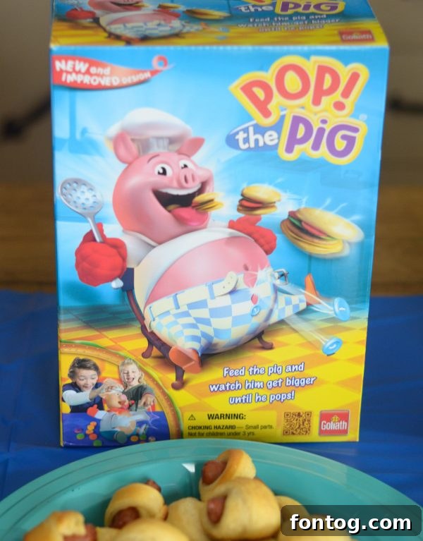 Children intently playing Giggle Wiggle, trying to place marbles on the wiggling caterpillar's hands. #GiggleWiggleGame