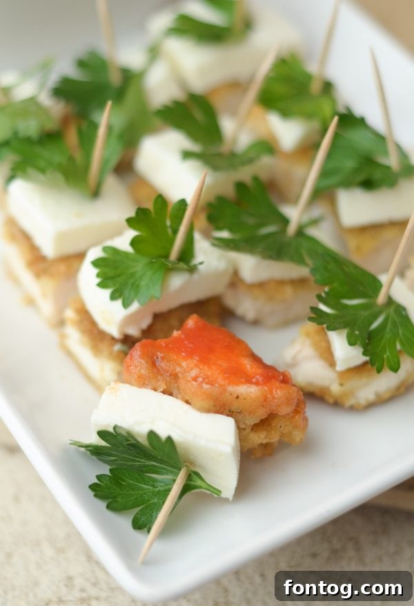 Festive Parmesan Herb Bites 2 Delicious Parmesan Herb Bites, a perfect easy holiday appetizer made with Tyson chicken strips, served on a platter.