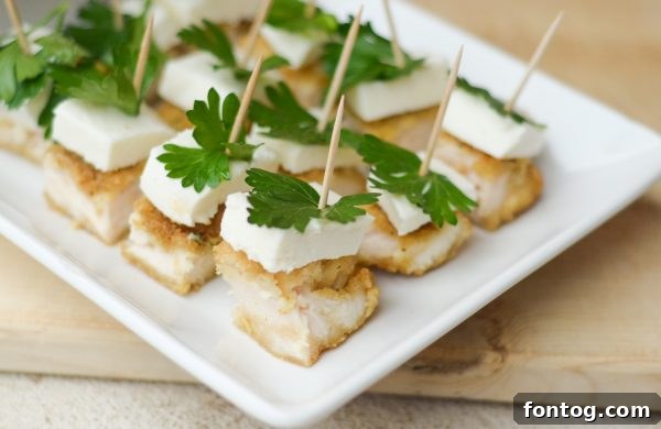 Festive Parmesan Herb Bites 6 Cooked Tyson Parmesan Herb Encrusted Chicken Strips, sliced and ready for assembly into bites.