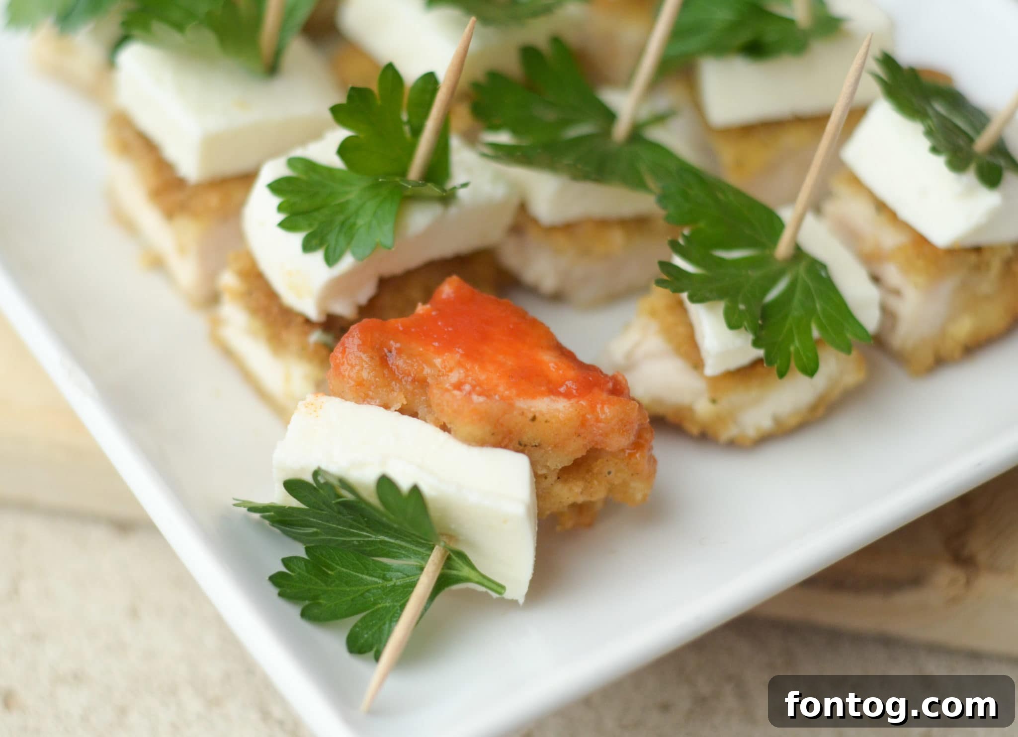 Beautifully arranged Parmesan Herb Bites with marinara sauce.