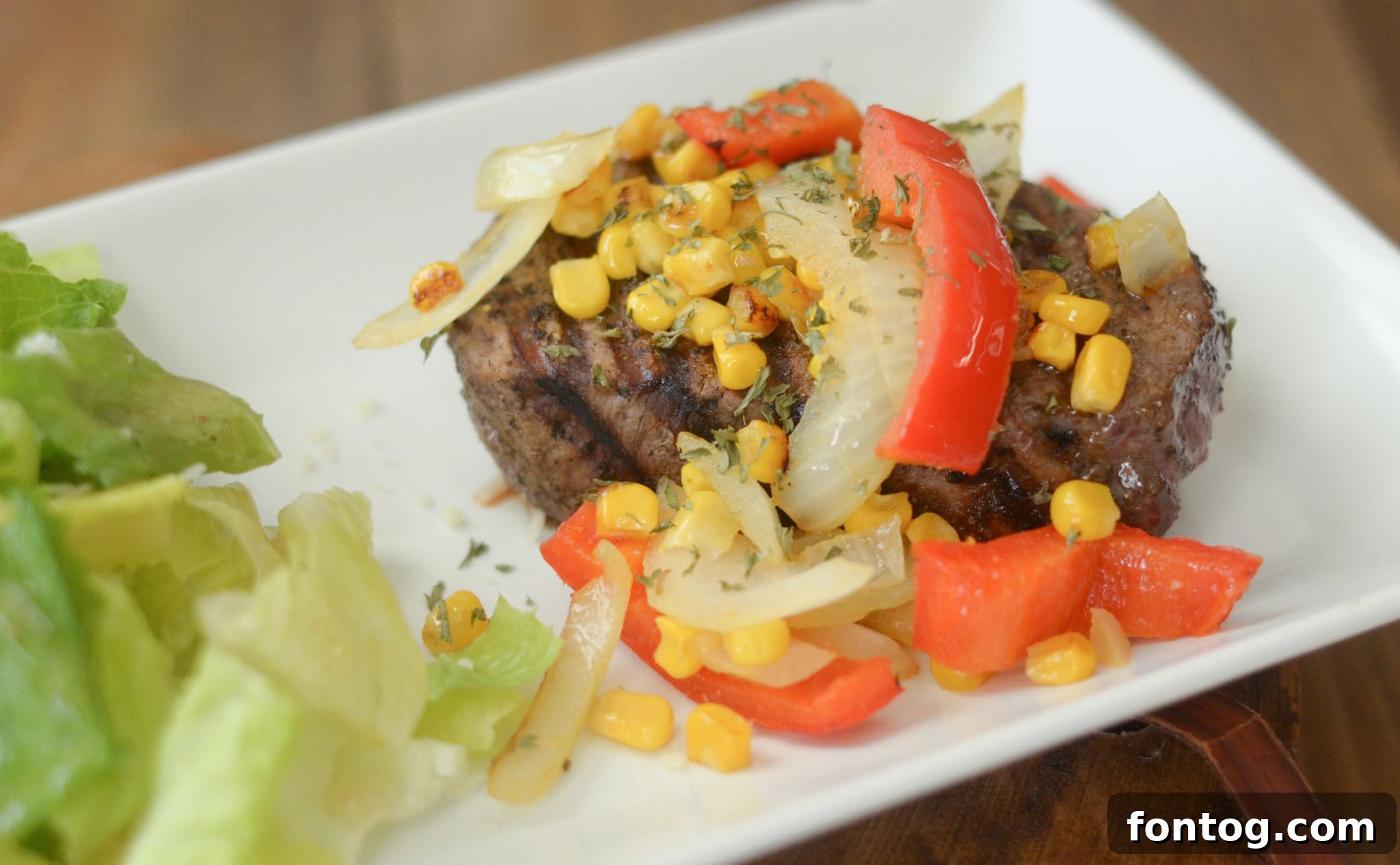 Veggie Topped Filet Mignon with vibrant vegetables