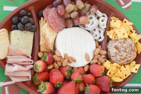 Touchdown Bites: Hosting the Ultimate Homegate with a Football Cheese Board 5 Football party table with snacks and Dr Pepper