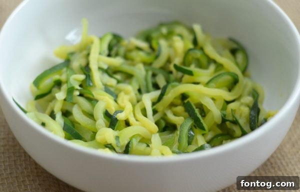 A close-up shot of perfectly steamed Green Giant Zucchini Spirals in a bowl, illustrating their readiness to be incorporated into various delicious and healthy recipes.