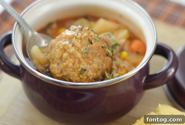 Cozy Instant Pot Meatball Soup 4 A bowl of Instant Pot Meatball Soup on a rustic wooden surface.