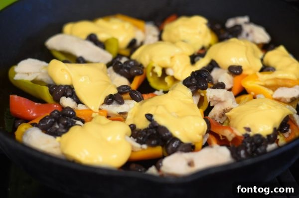 Serving of Cheesy Sweet Pepper Nachos in a cast iron skillet.