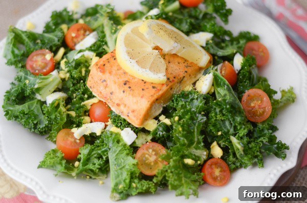 Appetizing salmon served with a vibrant lemon tossed kale salad