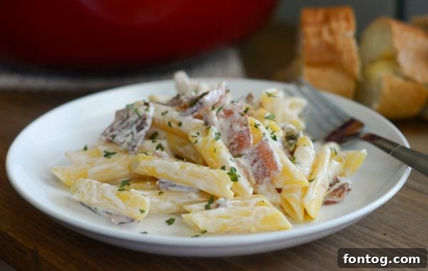 Creamy Penne Chicken Alfredo with smoked bacon, a rich pasta dish