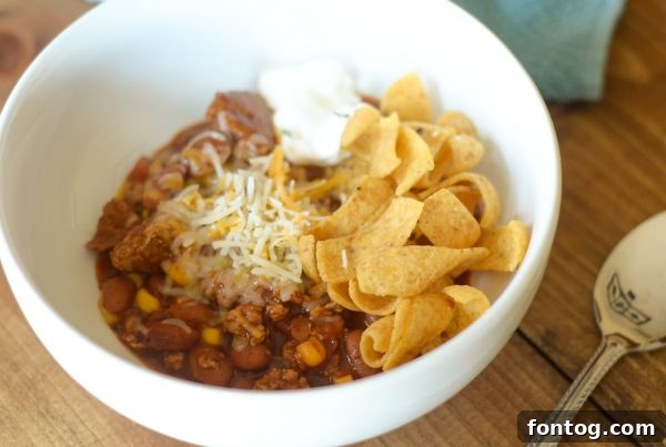 Preparing a bowl of Gluten-Free Turkey & Corn Chili, ready to serve