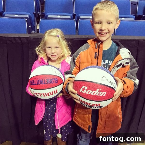 Kids holding Harlem Globetrotters basketballs