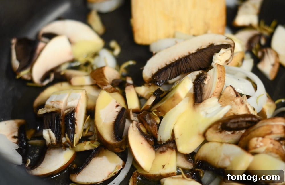 Close-up of the rich and savory lentil and vegetable filling in Vegan Shepherd's Pie.