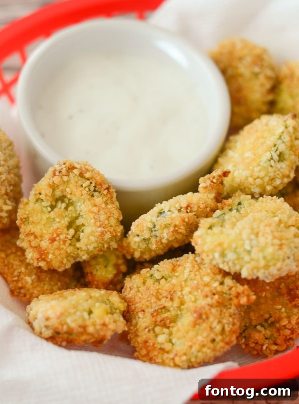Air Fryer Fried Pickles – Crispy, golden-brown fried pickle slices in an air fryer basket, ready to be dipped.