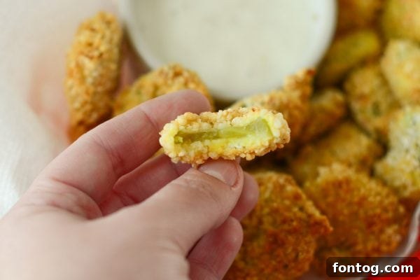 A close-up shot of the breaded pickle slices, ready to go into the air fryer.