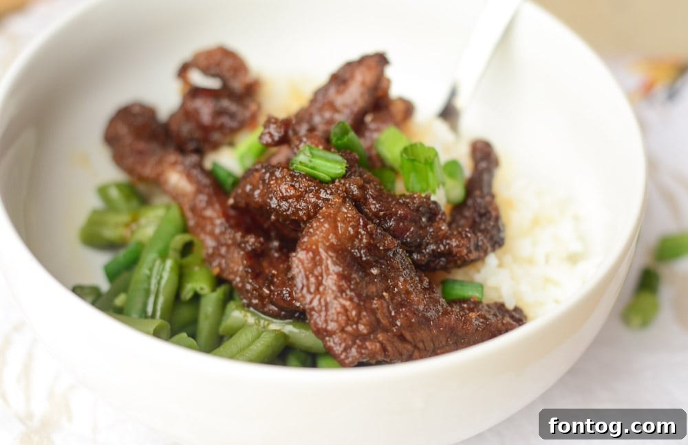 Air Fryer Mongolian Beef plated with rice