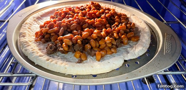 Taco Pizza: Deliciously Customizable (Gluten-Free Friendly) 3 Taco pizza ingredients spread on a gluten-free crust before baking.