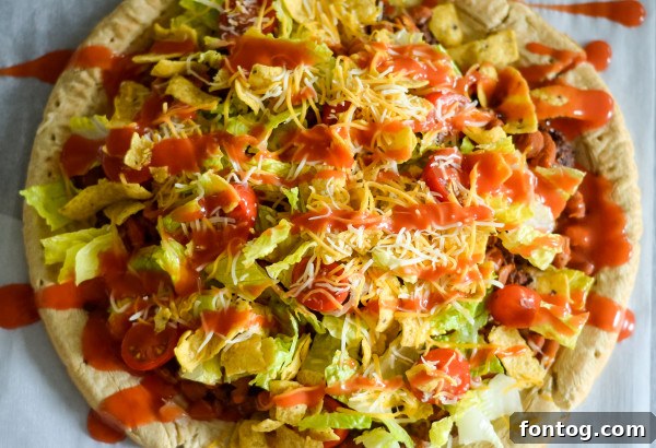 Taco Pizza: Deliciously Customizable (Gluten-Free Friendly) 4 Crispy baked taco pizza with a generous spread of ground beef and beans.