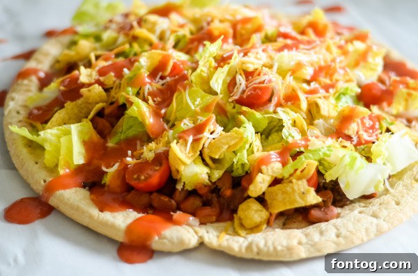 Taco Pizza: Deliciously Customizable (Gluten-Free Friendly) 5 Freshly baked taco pizza with toppings, ready to be served.