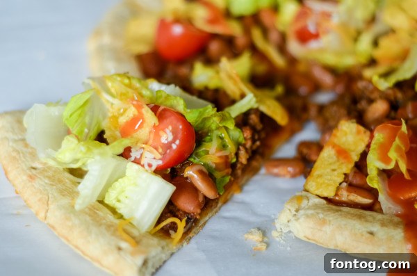 Taco Pizza: Deliciously Customizable (Gluten-Free Friendly) 6 A close-up of a slice of homemade taco pizza, showing layers of beef, cheese, and fresh toppings.