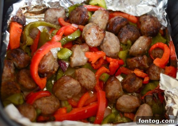 Close-up of air-fried bratwurst and vegetables with slight char