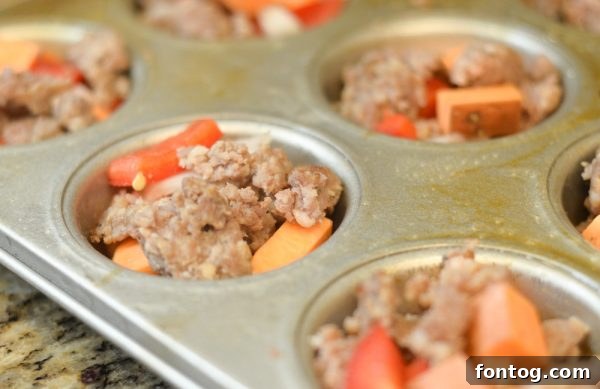 Ingredients for Gluten-Free Sweet Potato & Sausage Egg Cups laid out on a cutting board.