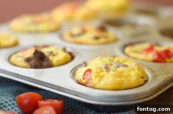 A serving of Gluten-Free Sweet Potato & Sausage Egg Cups with a side of gravy.