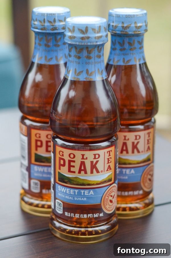Family enjoying Gold Peak Sweet Tea by the lake during a summer vacation