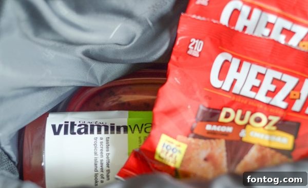 A happy family taking a snack break on the trail, demonstrating the importance of refueling during a hike.