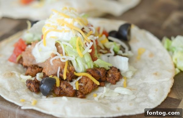 Close-up of a Gluten Free Air Fryer Tostada loaded with fresh ingredients.