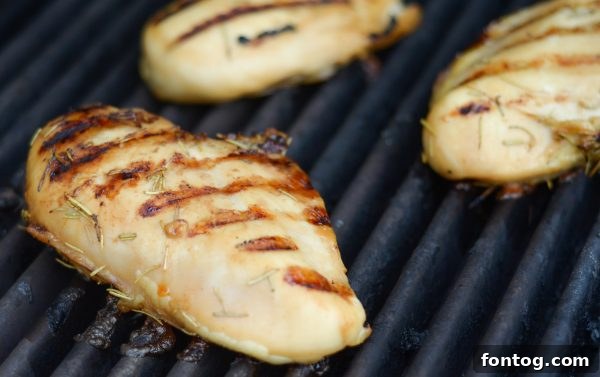 Grilled Garlic Rosemary Glazed Chicken served with corn and greens