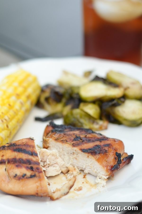 Plate of finished Grilled Garlic Rosemary Glazed Chicken with a side salad