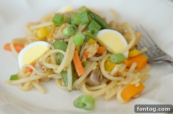 Flavorful Gluten Free Chicken Pad Thai garnished with fresh cilantro and lime