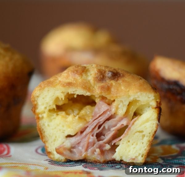 Irresistible Ham and Cheese Popovers 2 Golden brown ham and cheese stuffed popovers cooling on a rack, ready to be served.