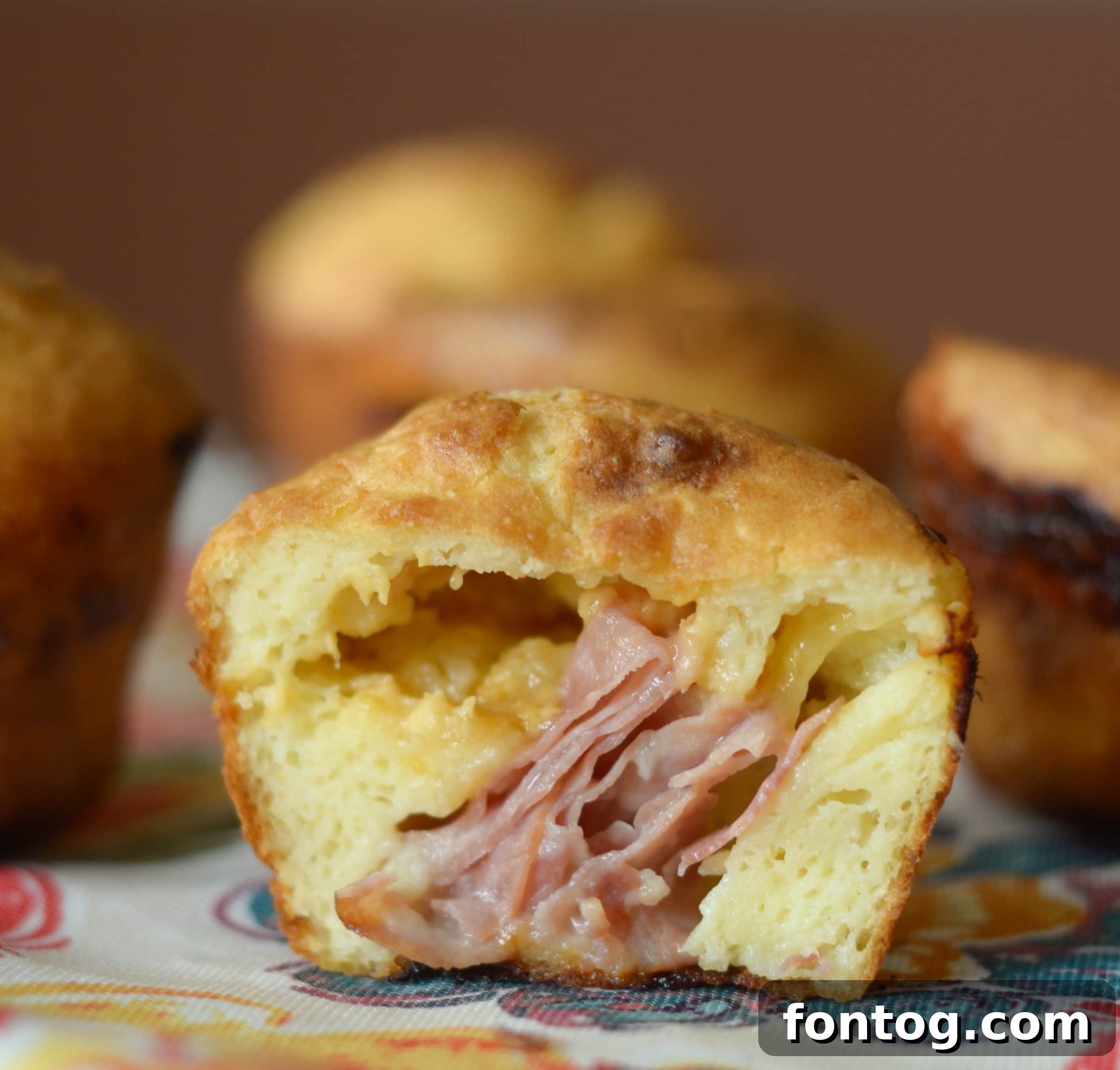 Golden brown ham and cheese stuffed popovers fresh from the oven.