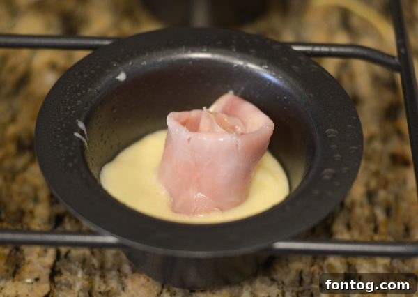 Close up of a popover pan, emphasizing its deep cups.