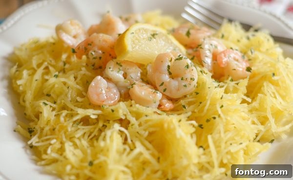 Gluten-Free Shrimp Scampi with Spaghetti Squash, garnished with fresh parsley and lemon.