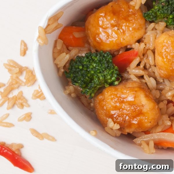 A mouth-watering close-up of Tai Pei General Tso's Spicy Chicken, highlighting the rich sauce and perfectly cooked chicken.