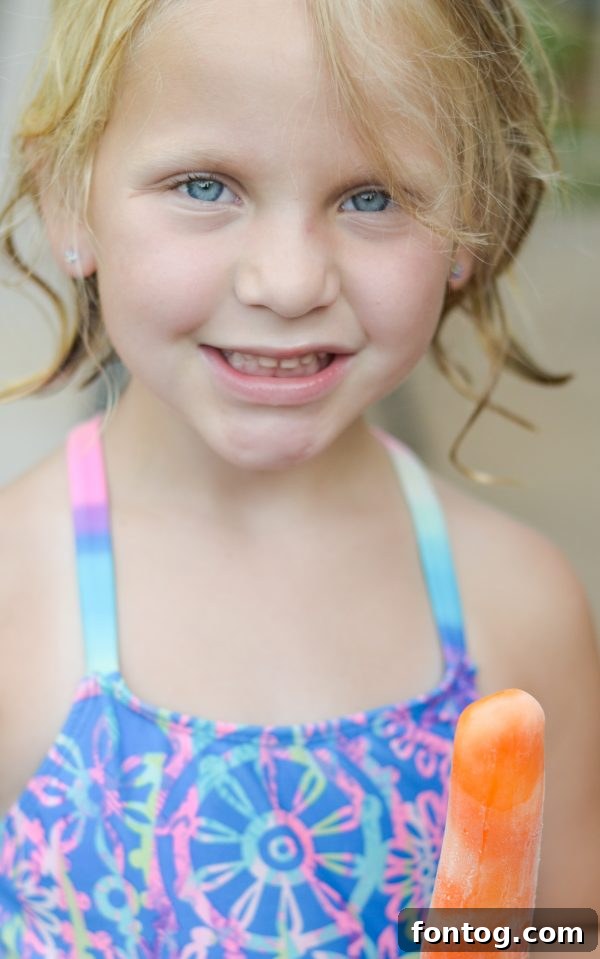 Summer Ice Pop Bash 2 Two children enjoying colorful ice pops by the pool at a vibrant summer party