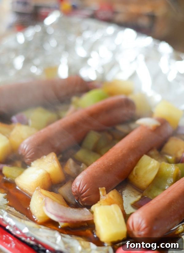 Assembling a Hawaiian Hot Dog with all the toppings
