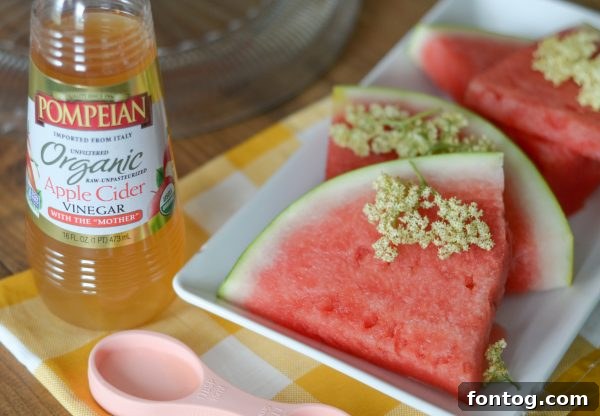 Watermelon Pineapple Punch with Elderflower being poured, showcasing the refreshing blend