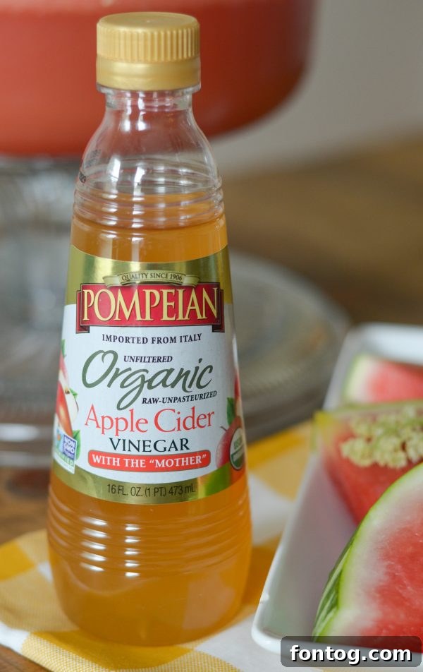 Ingredients for Watermelon Pineapple Punch with Elderflower, including Pompeian Organic Apple Cider Vinegar bottle