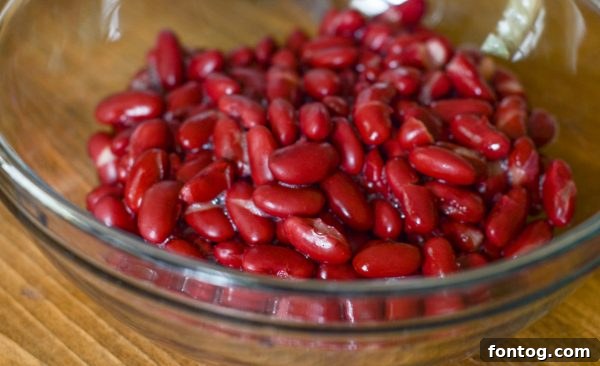 Bowl of Instant Pot Hearty Bean Chili with a side of cornbread and corn chips