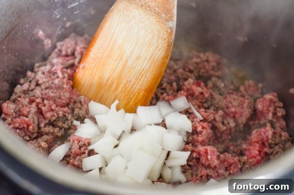 A bowl of Instant Pot Hearty Bean Chili with cheese and sour cream