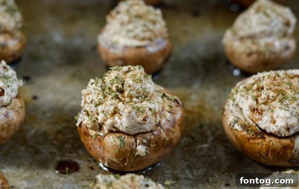 Balsamic Kissed Stuffed Mushrooms 4 Bottle of Pompeian Balsamic Vinegar next to fresh stuffed mushrooms.