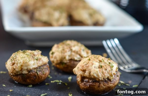 Balsamic Kissed Stuffed Mushrooms 6 Mushrooms on a baking sheet, ready for stuffing and baking.