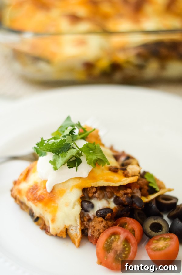 Delicious Gluten-Free Mexican Lasagna layered with corn tortillas and cheese