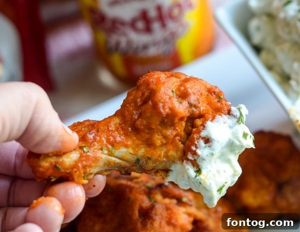 Close-up of crispy Frank's RedHot chicken wings, ready to eat.